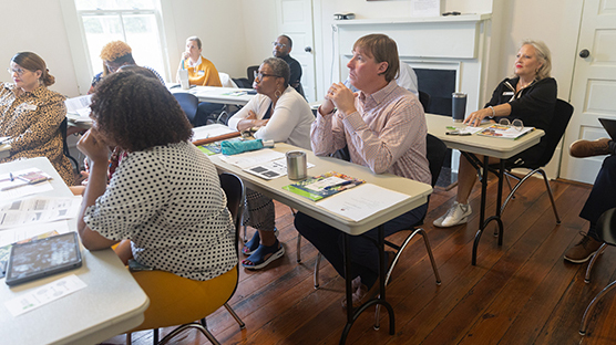 CEOE Advisory Council at September Meeting, members are seated at folding tables listening to a presentation