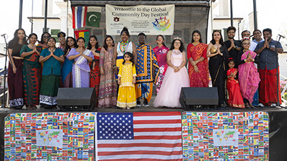 People on stage in cultural attire.