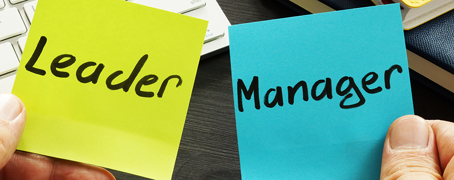 Neon green post-it that says 'Leader' on left, blue post-it that says 'Manager' on right.