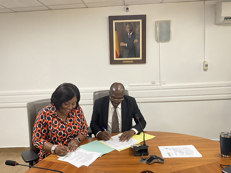 Two people signing documents