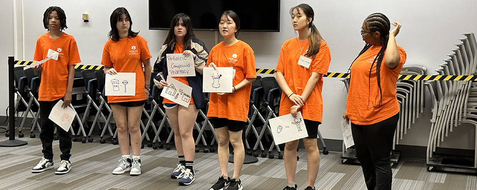 6 students standing a giving a presentation.