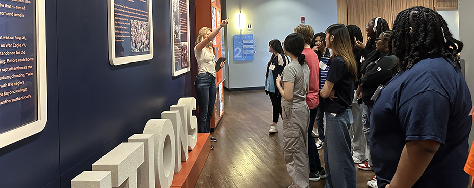 Group of students listening to a woman give a tour in the AU Student Center.