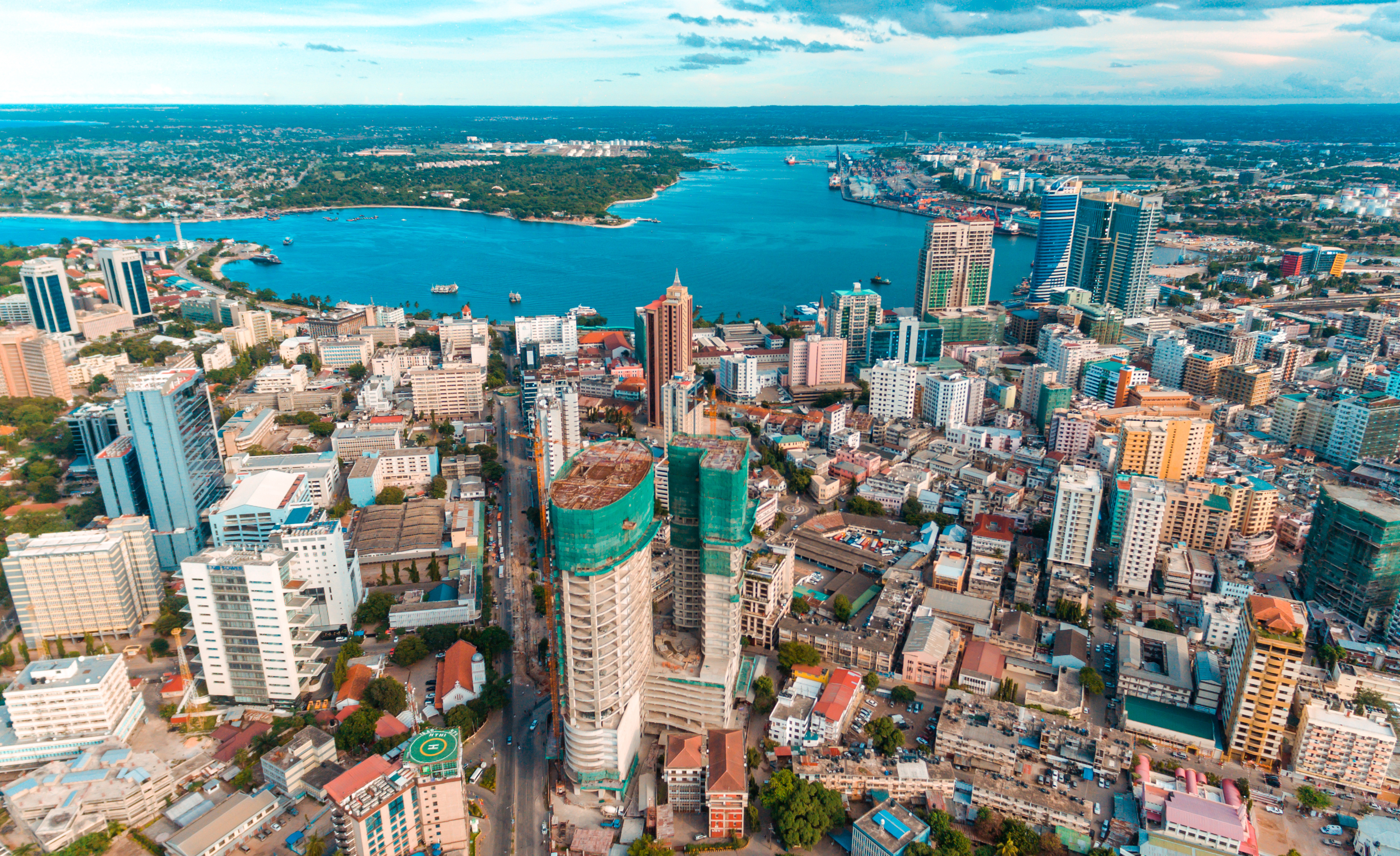 Skyscrapers with a body of water in the background.