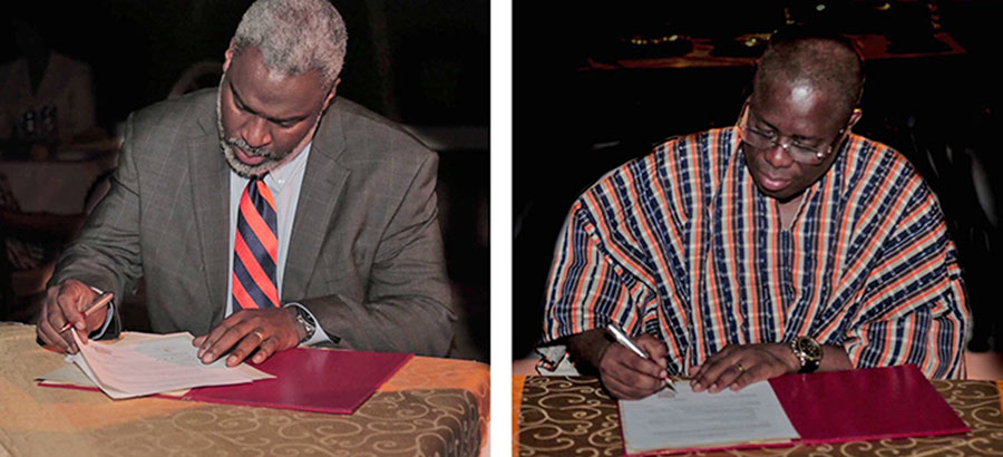 representatives of Auburn and University of Cape Coast signing MOU documents