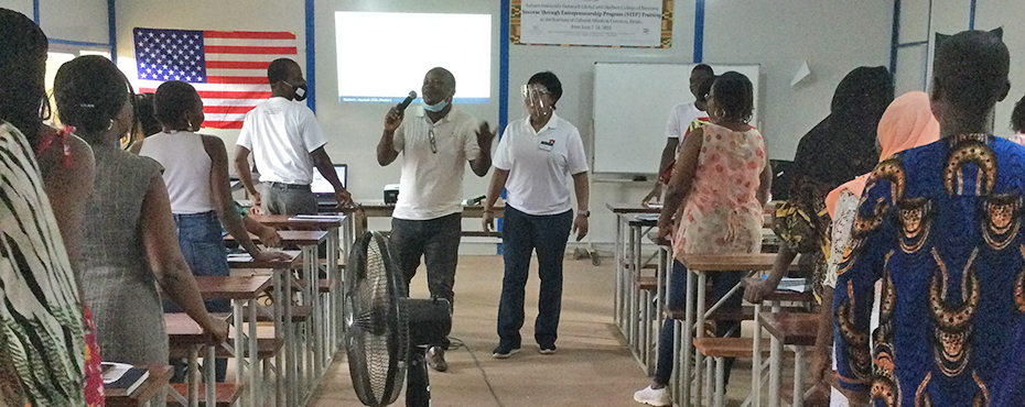 Two instructors stand in front of class during training