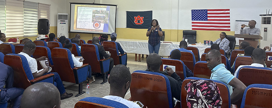 A woman speaks in front of a group of students.