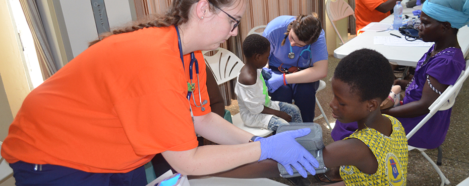 female checking a child's blood pressure