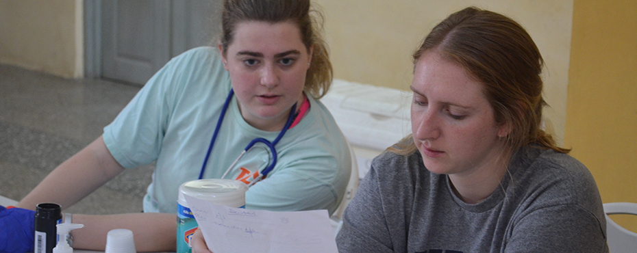 two female students review notes