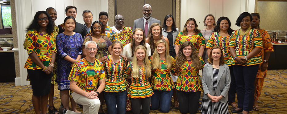 group of instructors and students pose for a picture with Dr. Cook