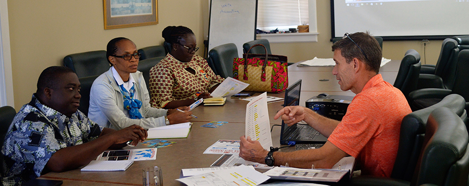 several instructors sit around a conference table