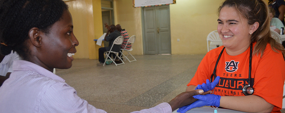 health worker examining a patients hand