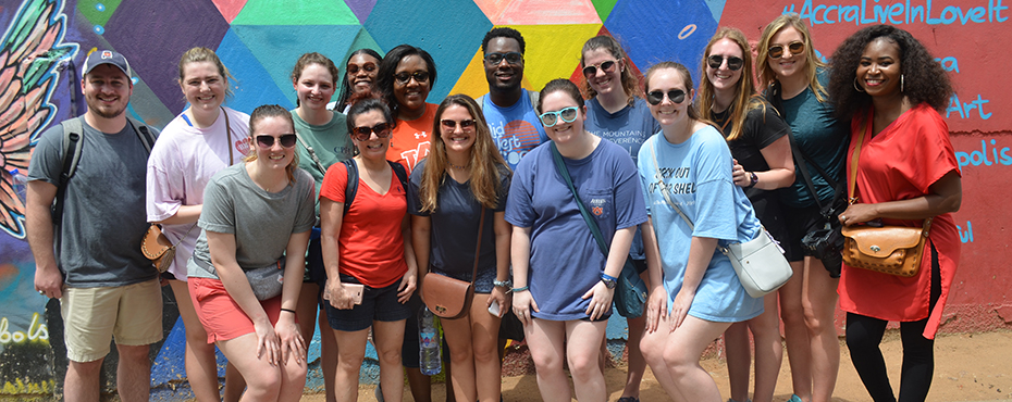 group of students posing for a picture while traveling