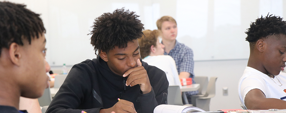 Campers listen to the instructor while they practice in their ACT books.