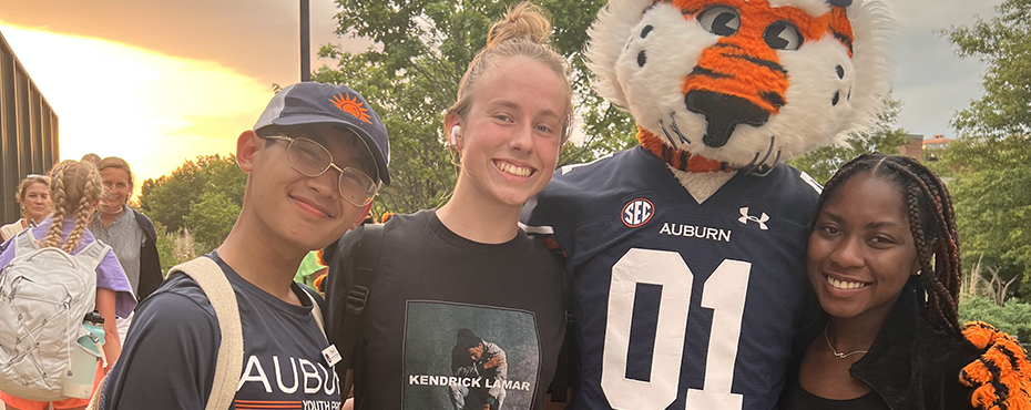 Campers and AYP Counselor pose outside with Aubie the Tiger.