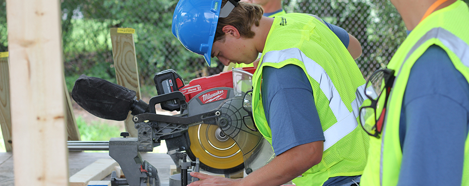 Student sawing a 2x4