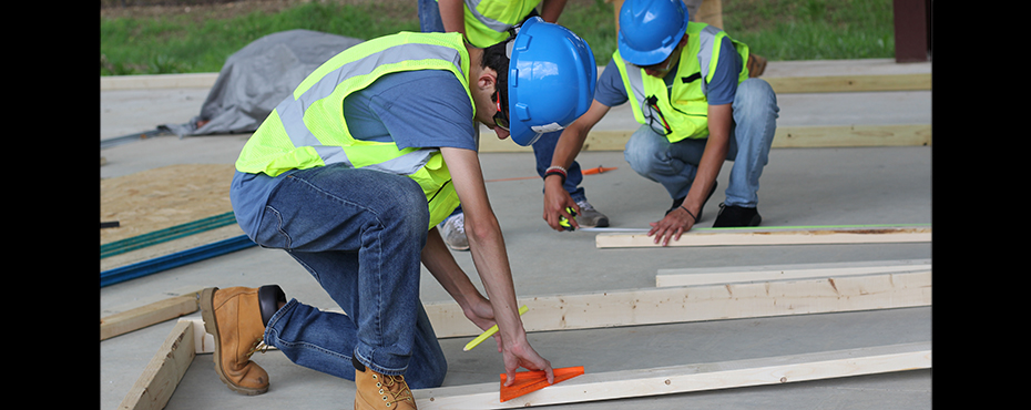 Student measuring a 2x4