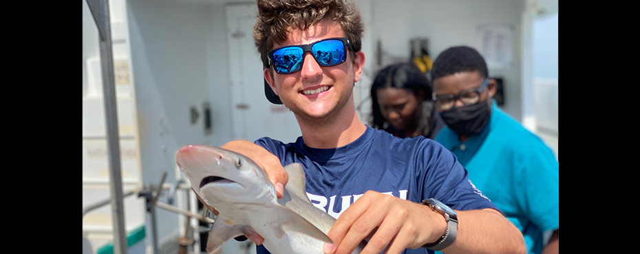 Camp counselor holding a small shark