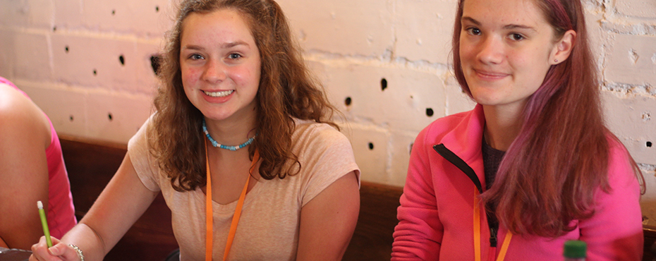 Two students posing with their pages