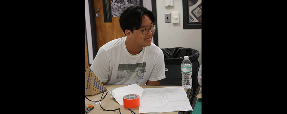Guy smiles in classroom
