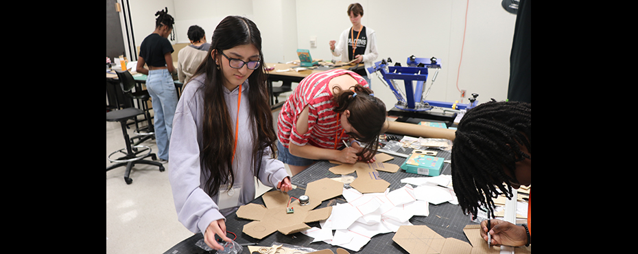 Two girls work on a project