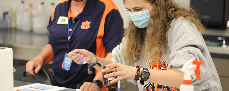 Student mixing powders in a jar