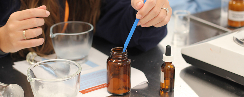 Student measuring a compound