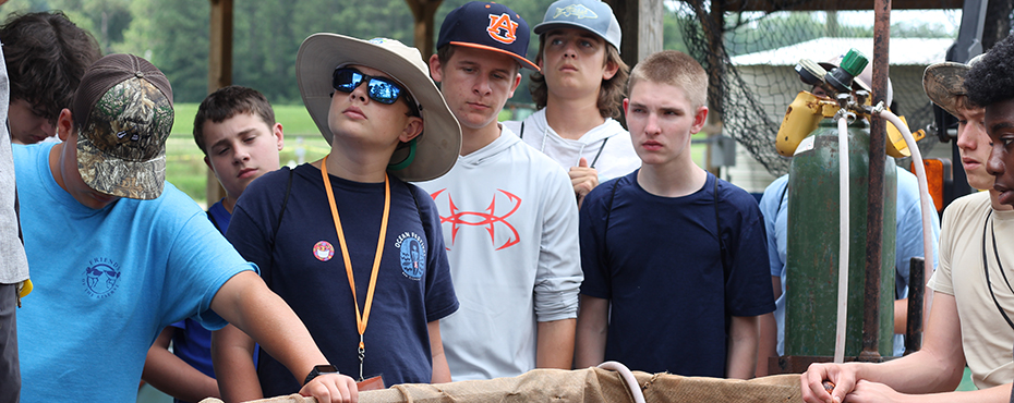 Group of students listening to an instructor