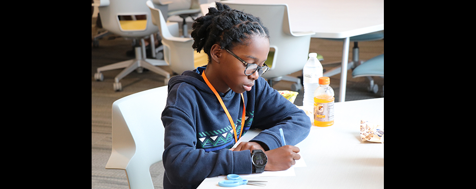 Student works on paper in classroom