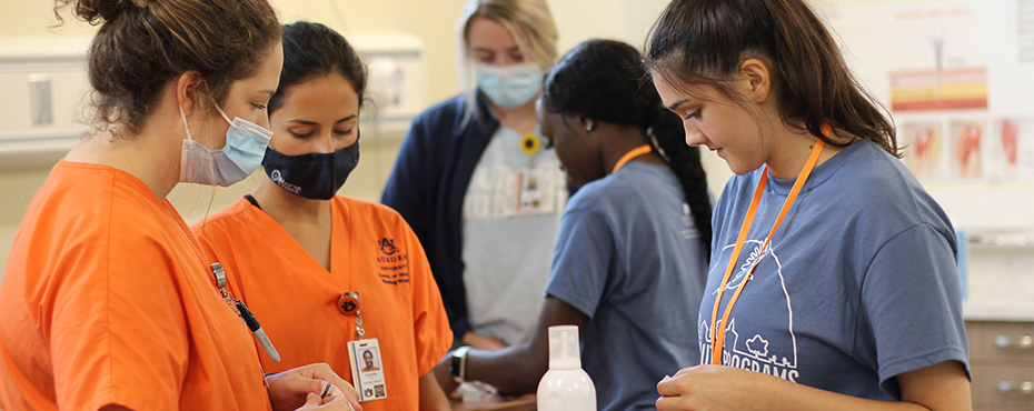 Students practicing giving a vaccine