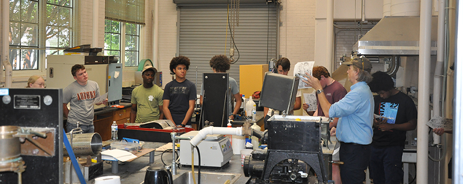 Group of campers posed in front of International Paper Mill