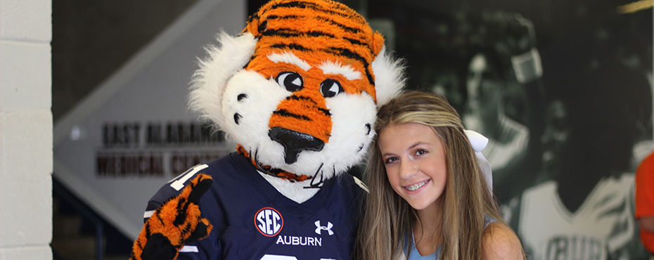 Aubie posing with dancer