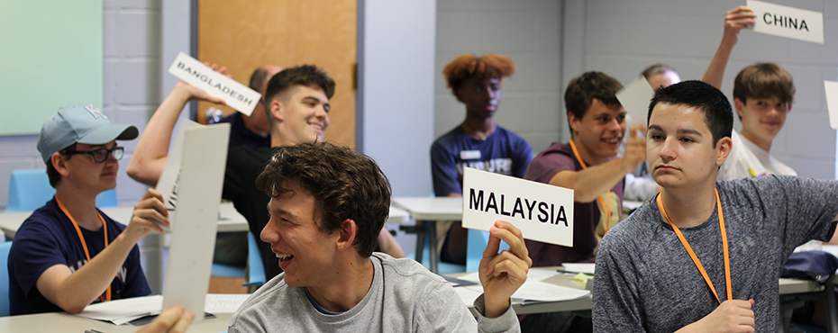 Students raising placards to debate