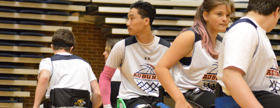 Wheelchair basketball campers line up to participate in drills while at camp.