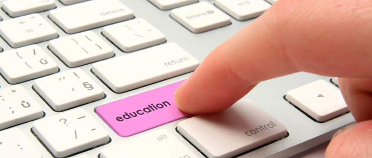 Keyboard with Shift key replaced with a purple key named Education that has a person's finger pressing the Education key.