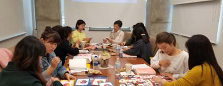 students sitting around a table working on projects