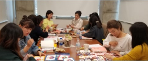 students sitting around a table working on projects