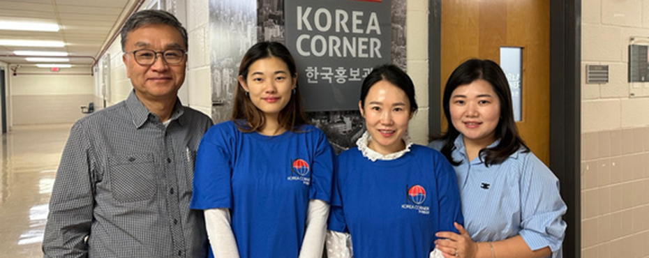 4 people in front of sign