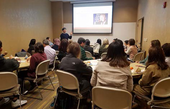 people viewing a presentation in a small conference room