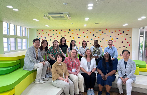 group of adults sitting in an elementary classroom