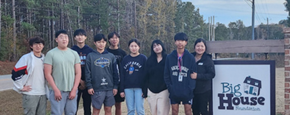 group of students standing in front of the Big House Foundation