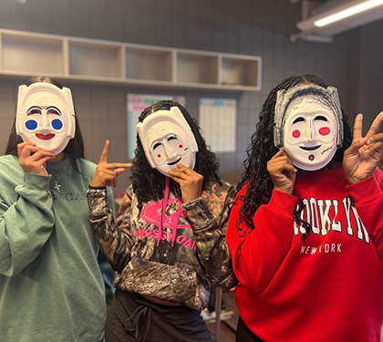 Group of people standing on stairs outside in native attire