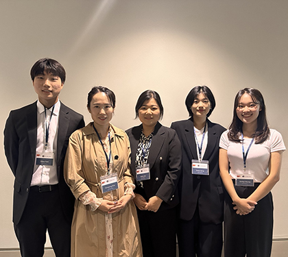 Five students wearing name tags