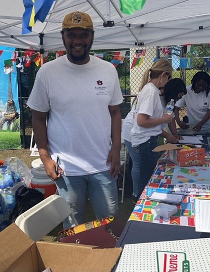 Americorp Vista Volunterr working at the check in table for Global Community Day Festival